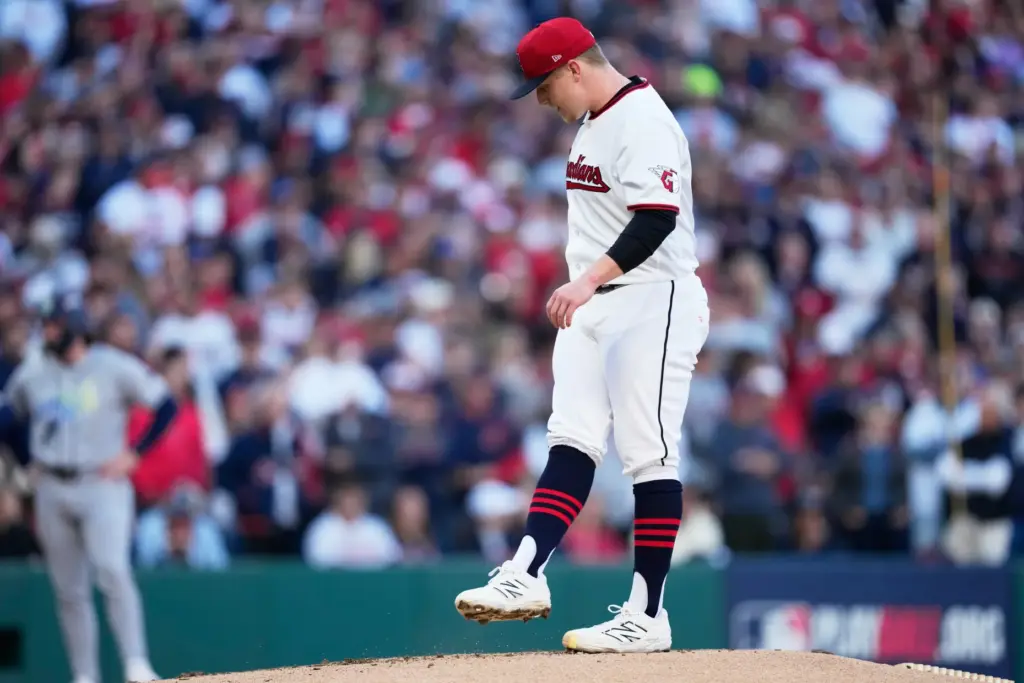 Cleveland Guardians pitcher Parker Messick reacts after walking in a...