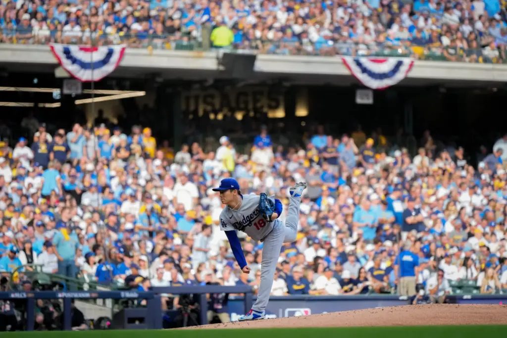 Dodgers starting pitcher Yoshinobu Yamamoto throws to the plate during...