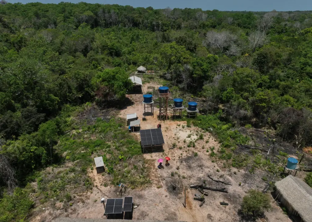 Solar panels operate near water tanks in Nova Sociedade, a...