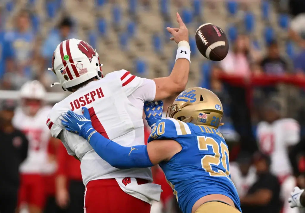 Linebacker Scott Taylor #20 of the UCLA Bruins sacks quarterback...