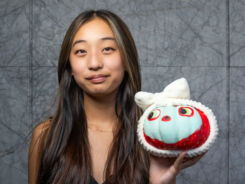 Cami Choi holds her pumpkin titled âFace-Masked Strawberryâ which she...