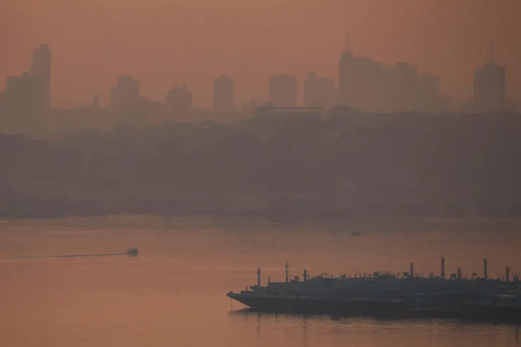 FILE – A fuel barge is visible on the Negro...