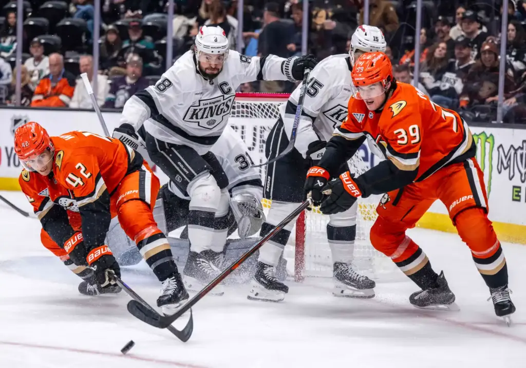 Anaheim Ducks and Los Angeles Kings players battle for the...