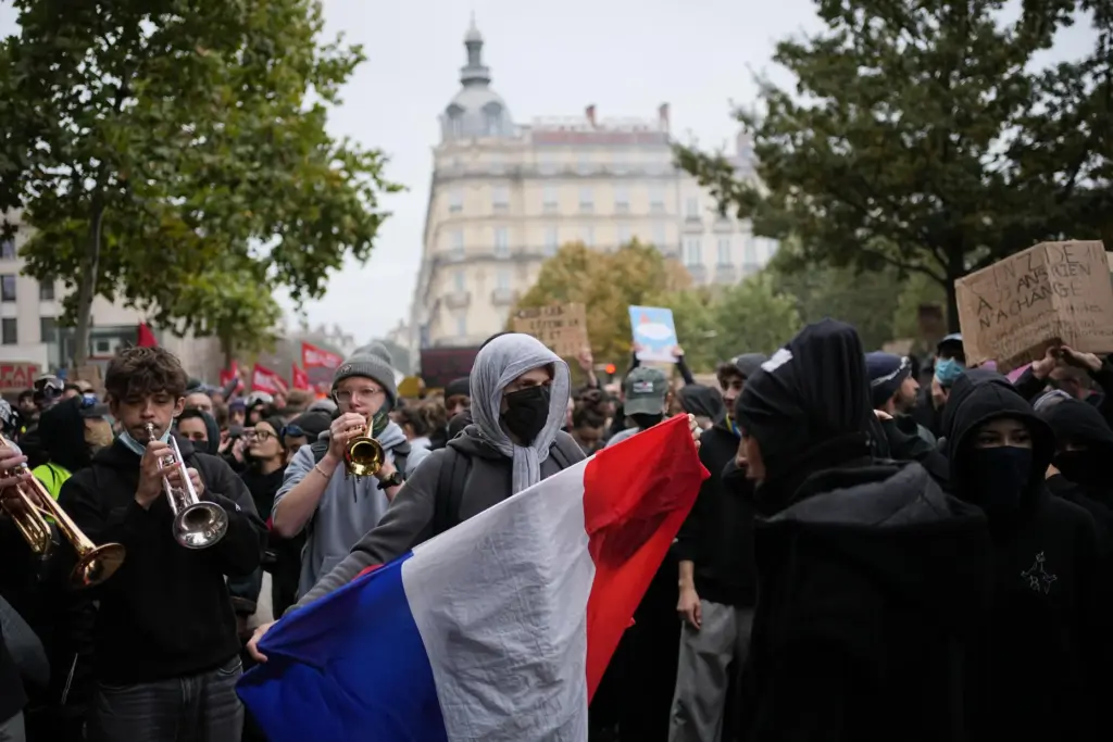 A protesters holds a French flag during a demonstration against...