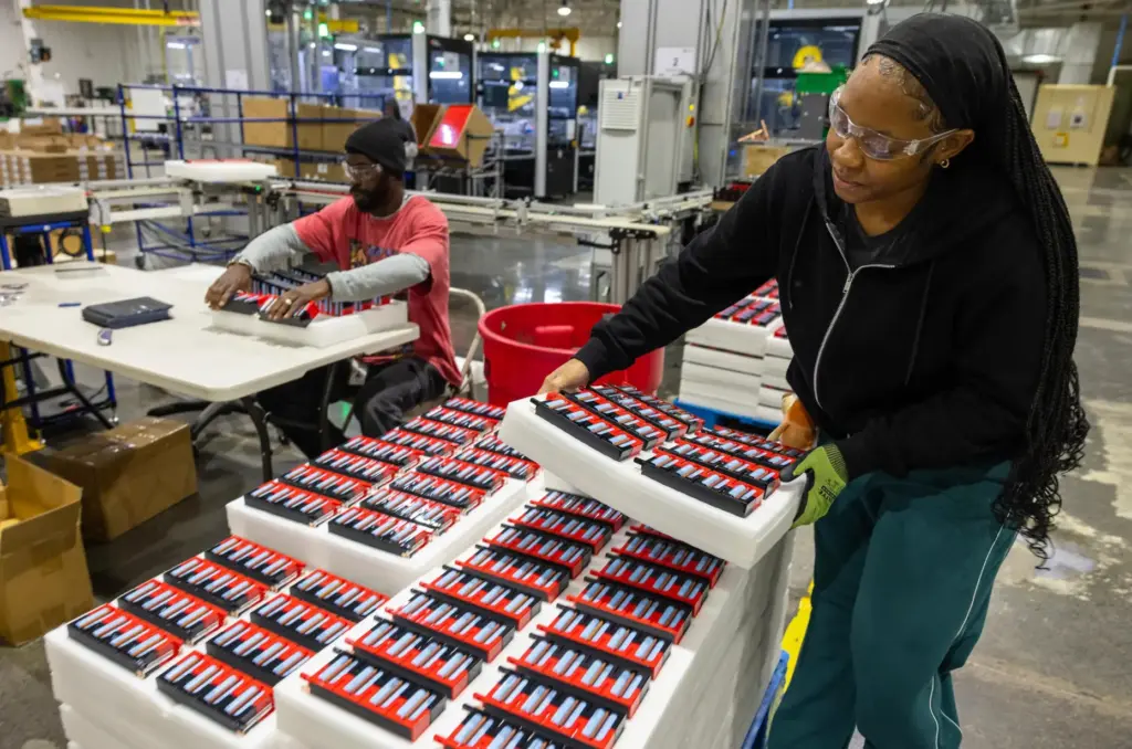Paige McNair stacks lithium-ion battery modules inside Viridi’s manufacturing plant...