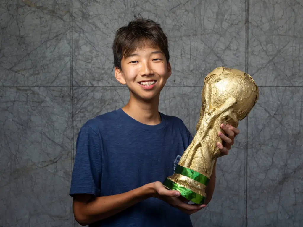 Eli Han holds his pumpkin titled âGlory in their Hands...
