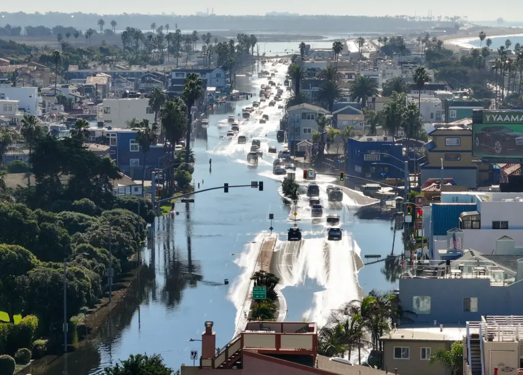 Sea water floods on to Pacific Coast Highway during high...