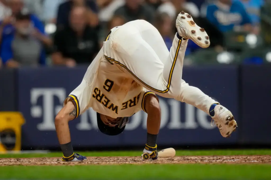 The Milwaukee Brewers’ David Hamilton falls after being hit by...