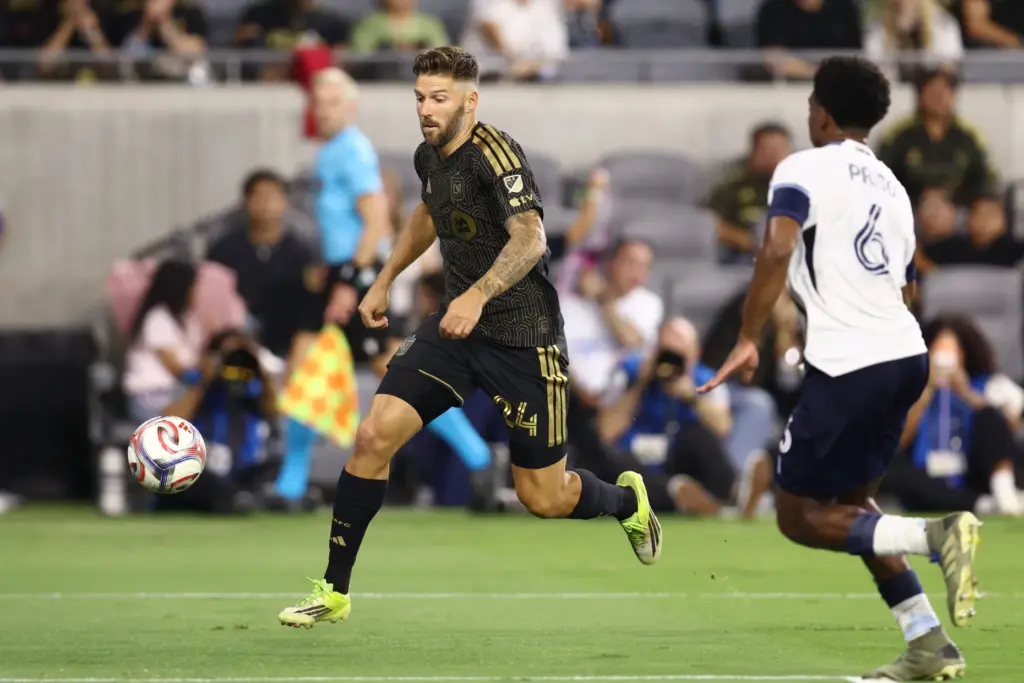 Los Angeles FC defender Ryan Hollingshead, left, chases the ball...