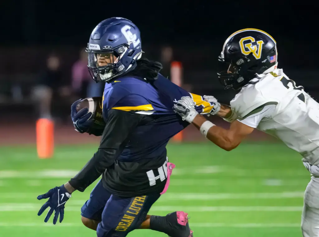 Capistrano Valley wide receiver Izaiah Bennett, right, tries to take...
