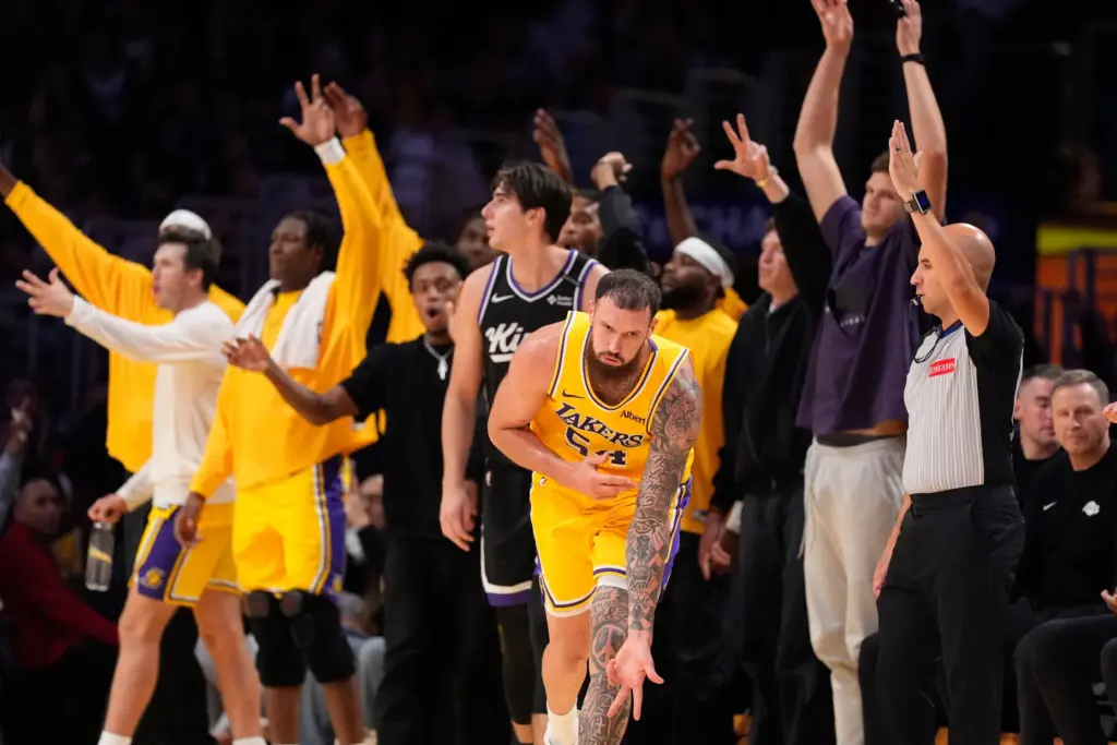 Lakers forward/center Sandro Mamukelashvili, center, celebrates after making a 3-point...