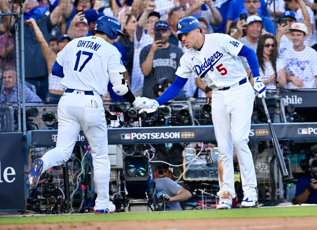 Dodgers star Shohei Ohtani, left, celebrates with teammate Freddie Freeman...