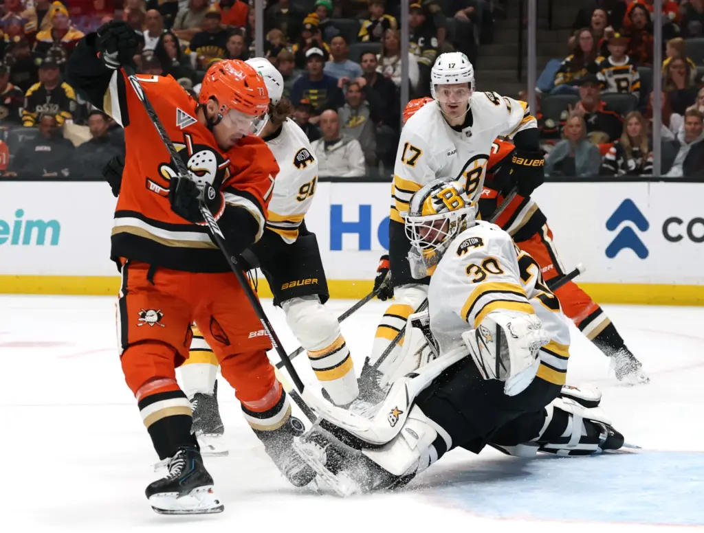 Boston Bruins goaltender Michael DiPietro, right, makes a save against...