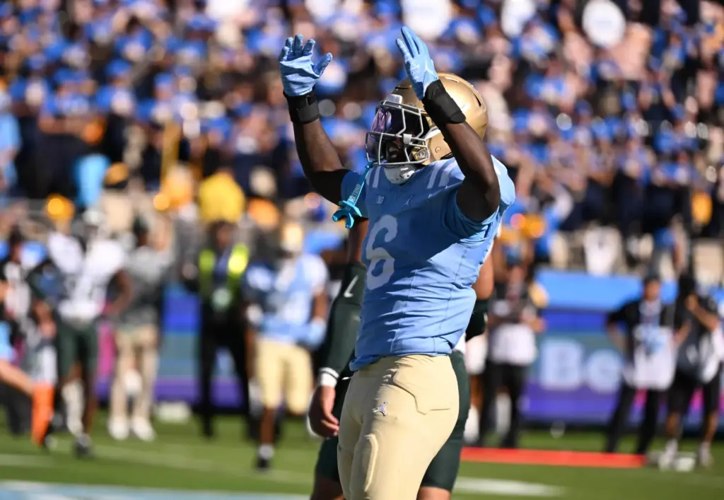 UCLA running back Anthony Woods (6) celebrates after scoring on...