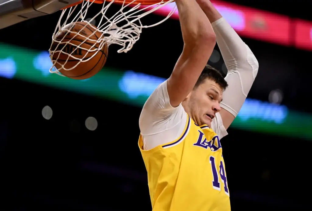 Lakers center Walker Kessler dunks during the second half of...