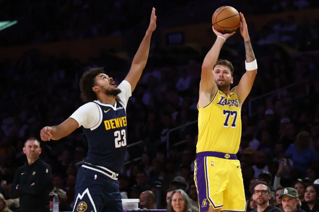 Lakers guard Luka Doncic shoots as Denver Nuggets forward Cameron...