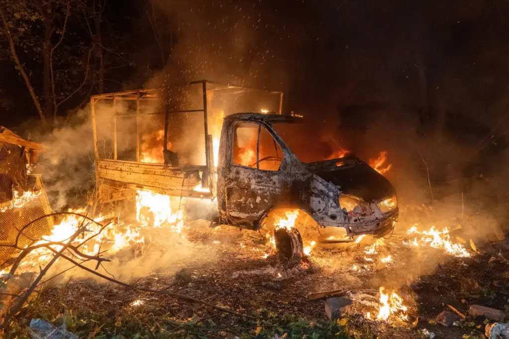 A car burns after a Russian drone strike on a...