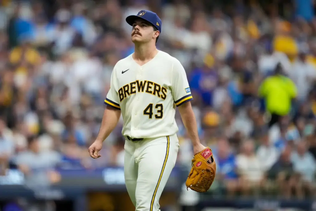 Milwaukee Brewers starting pitcher Logan Henderson walks off the field...