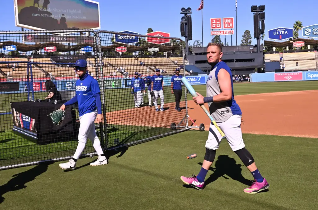 Dodgers infielder Miguel Rojas, right, walks on the field during...