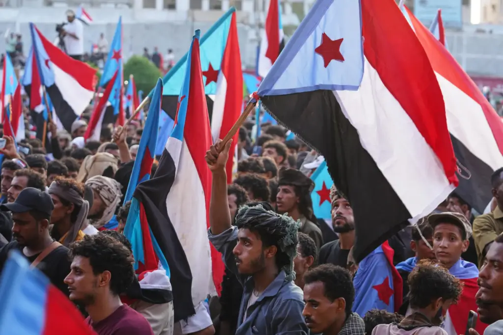 People wave national flags during a rally to celebrate the...