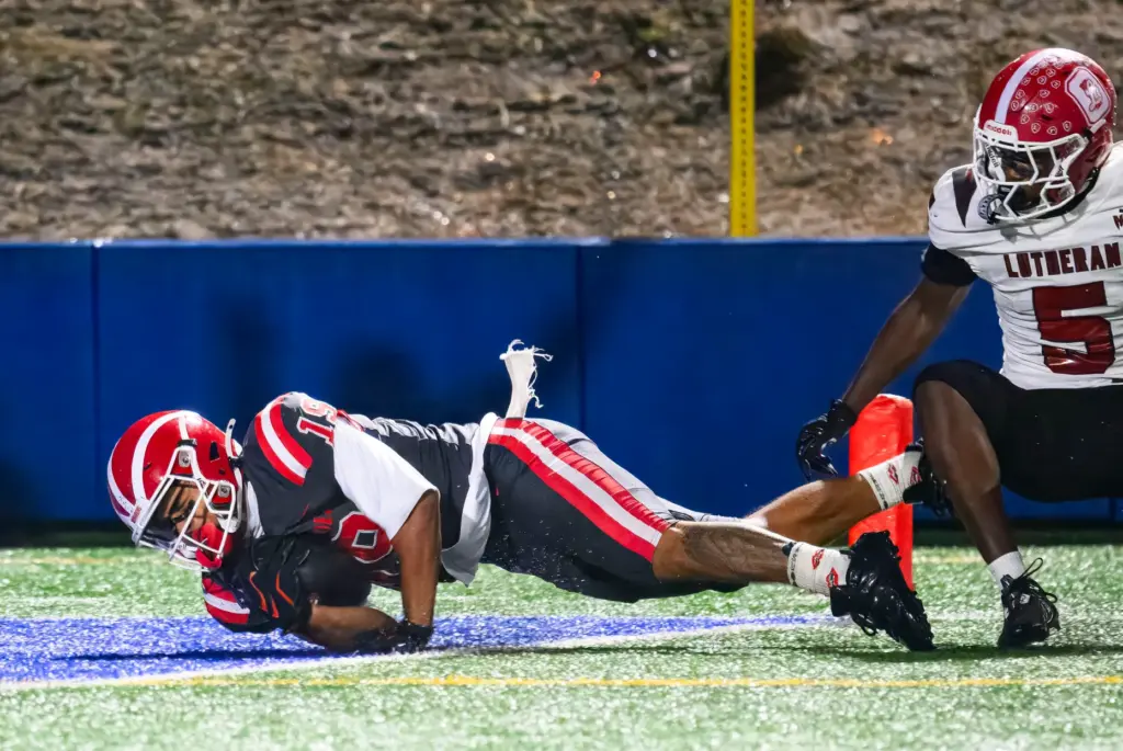 Mater Dei wide receiver Gavin Honore tumbles into the end...