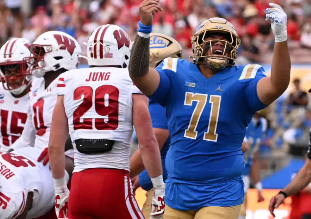 Offensive lineman Sean Na’a #71 of the UCLA Bruins reacts...