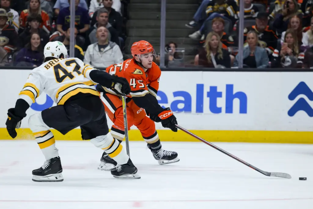 Ducks right wing Beckett Sennecke, right, shoots the puck as...