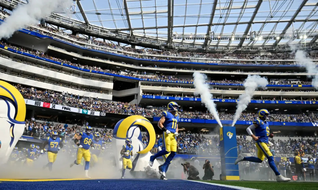 Rams quarterback Matthew Stafford (9), right, leads the team onto...