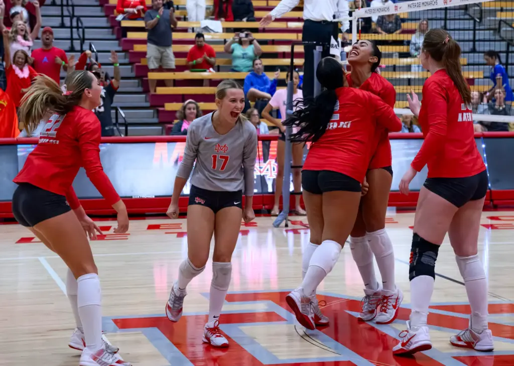 The Mater Dei volleyball team, including Sienna Cicero, center, celebrate...