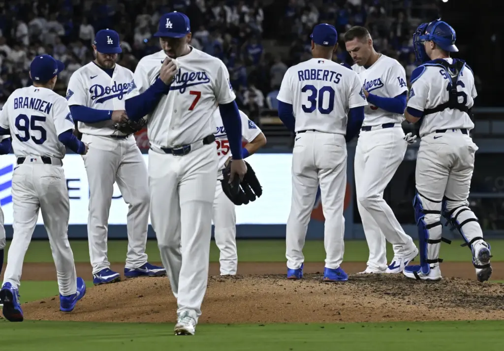 Dodgers starting pitcher Blake Snell walks off the field after...