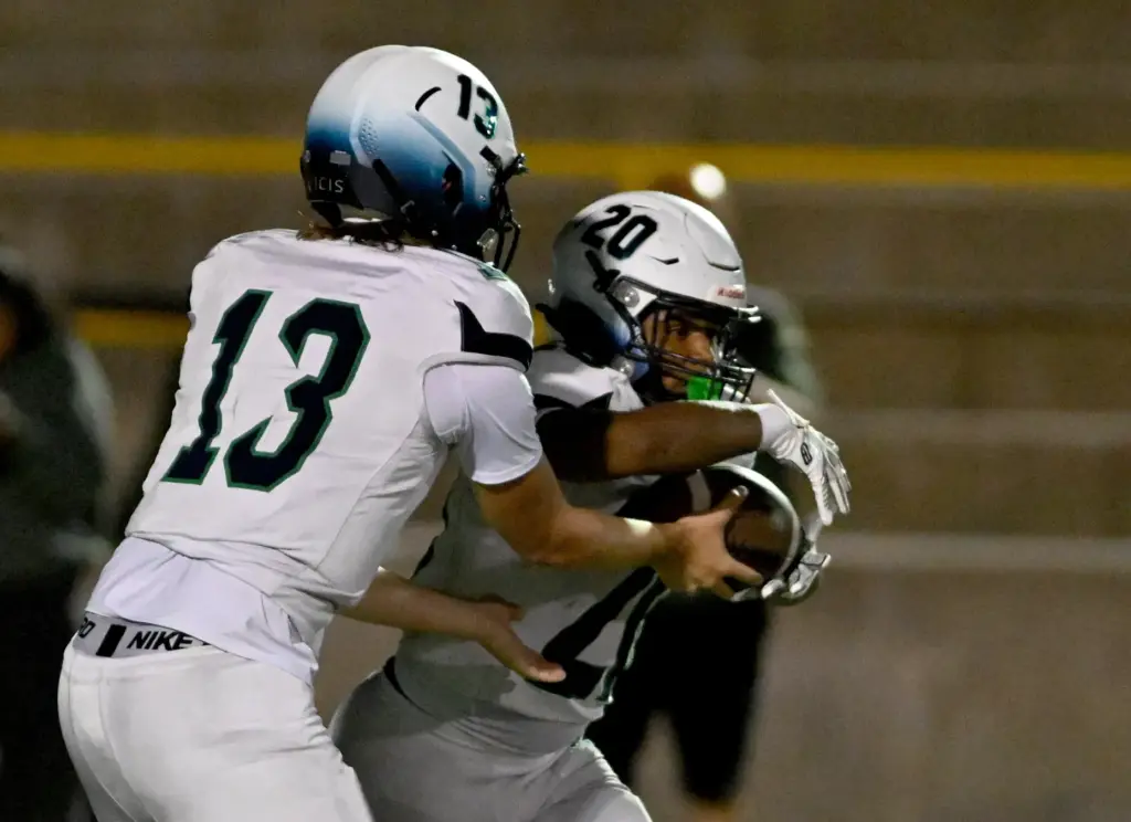 Chino Hills Huskies quarterback Daniel Mielke II (13) hands off...