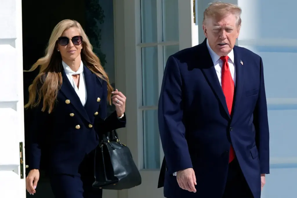 President Donald Trump walks out along with White House press secretary Katie Zacharia.