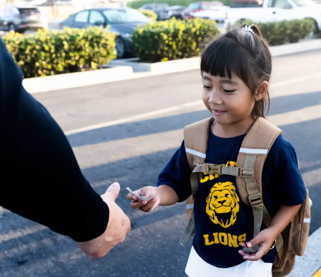A student gets a Westminster police sitcker at Schmitt Elementary...