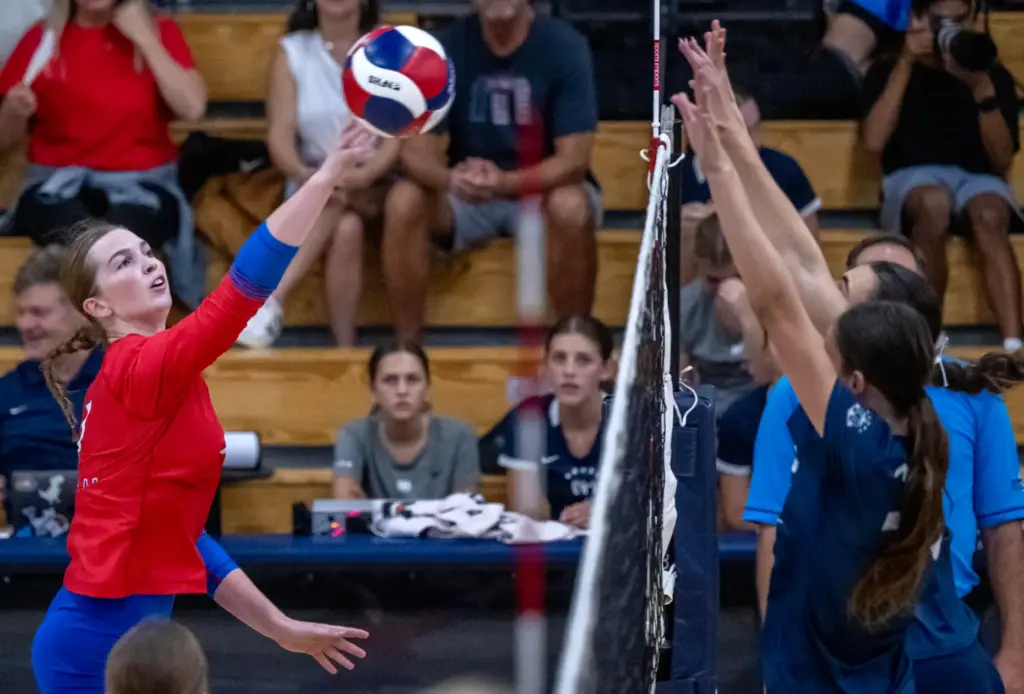 Los Alamitos middle blocker Grace Schroeder (7) hits the ball...