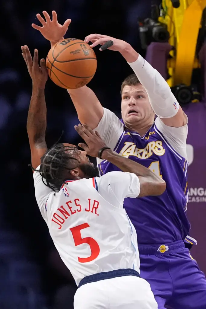 Lakers center Walker Kessler, right, blocks a shot by Clippers...