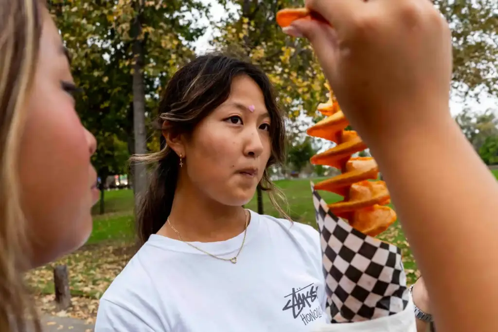 Mikayla Udan and Christine Kang enjoy a crispy potato on...