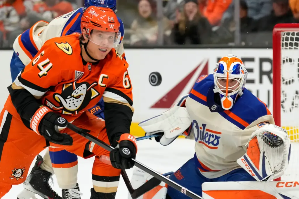 Ducks center Mikael Granlund, left, and Edmonton Oilers goaltender Devon...