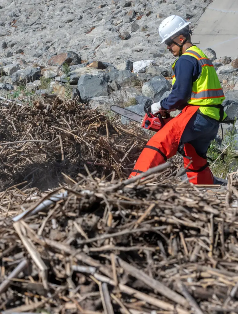 Workers clear the San Juan and Trabuco Creek flood control...
