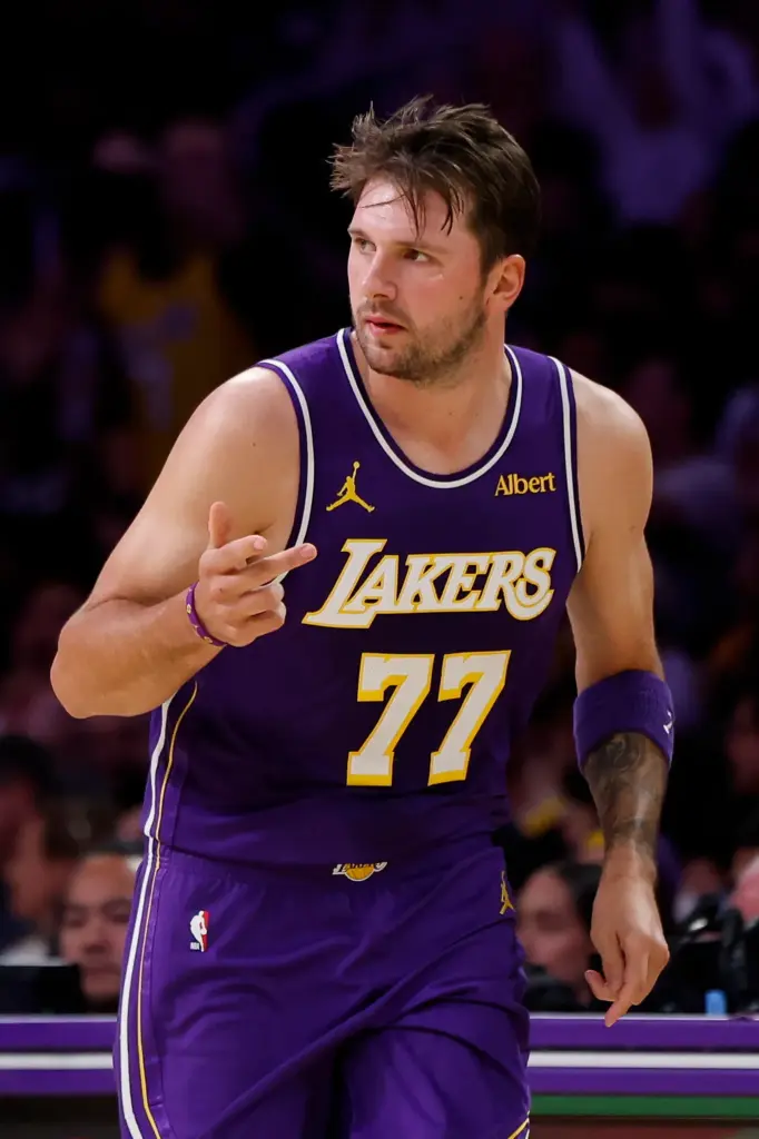 Lakers star Luka Doncic gestures after making a 3-point shot...