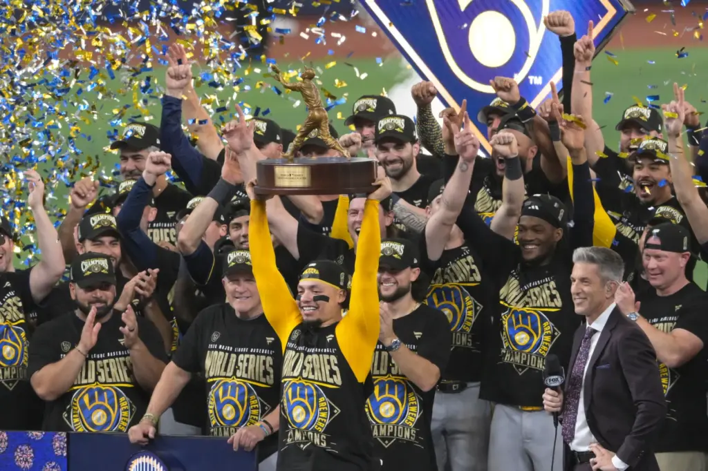 Milwaukee Brewers catcher William Contreras holds the MVP trophy after...