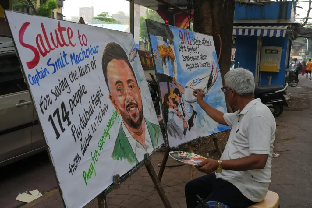 A teacher from Gurukul School of Art paints a portrait honoring Smit Machchhar.