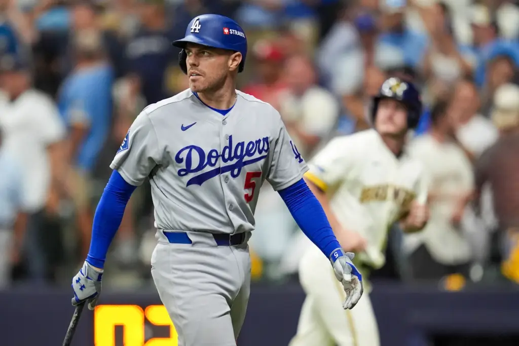 The Dodgers’ Freddie Freeman looks toward the scoreboard as he...