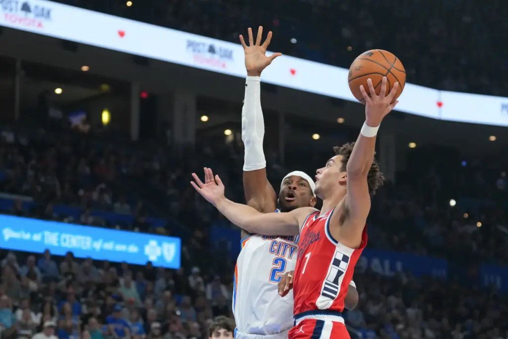 Clippers guard Keaton Wagler, right, shoots over Oklahoma City Thunder...