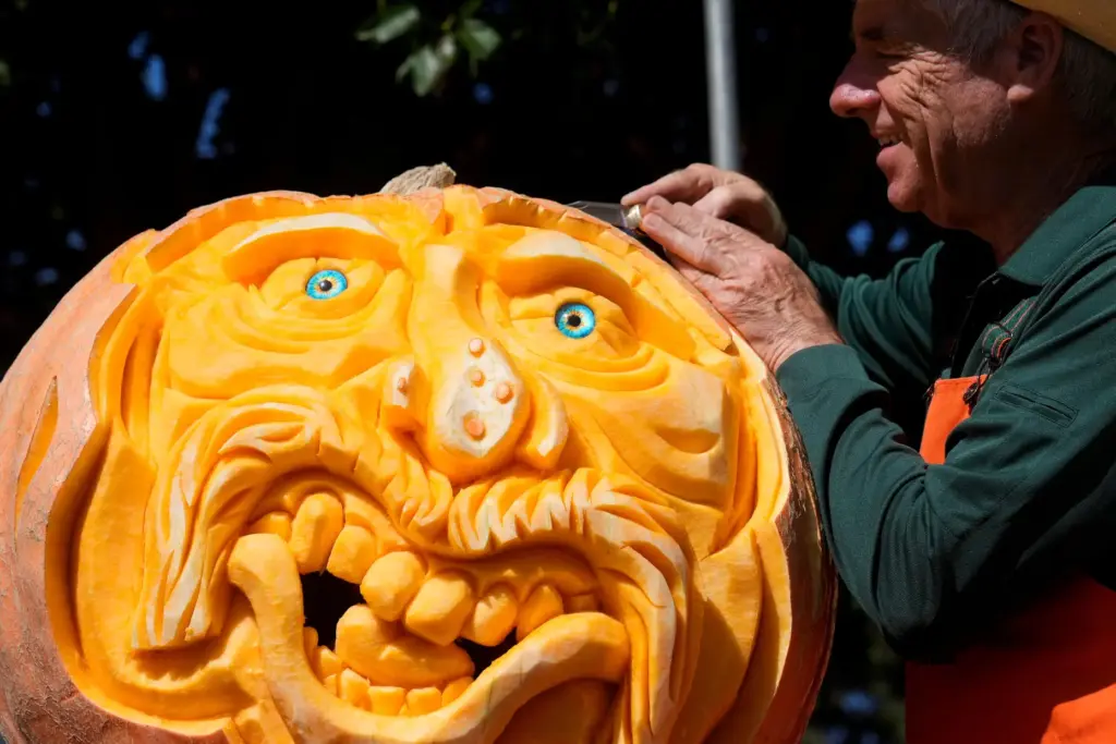 Farmer Mike Valladao carves a pumpkin at the Safeway World...