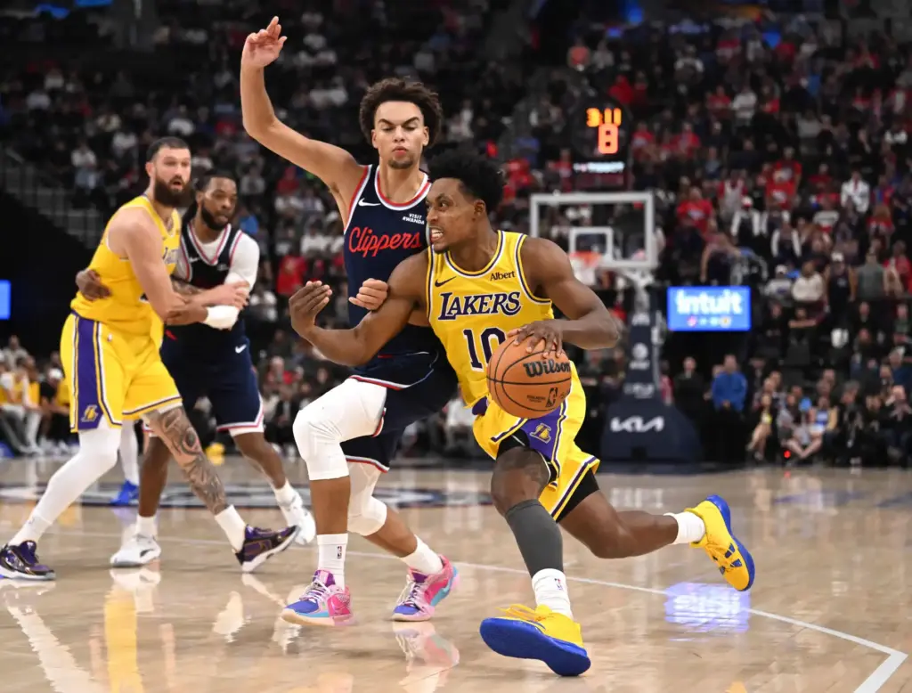 Lakers guard Collin Sexton drives to the basket as Clippers...