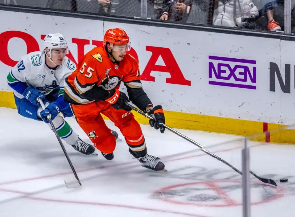 The Ducksâ Tyson Hinds, right, controls the puck as the...