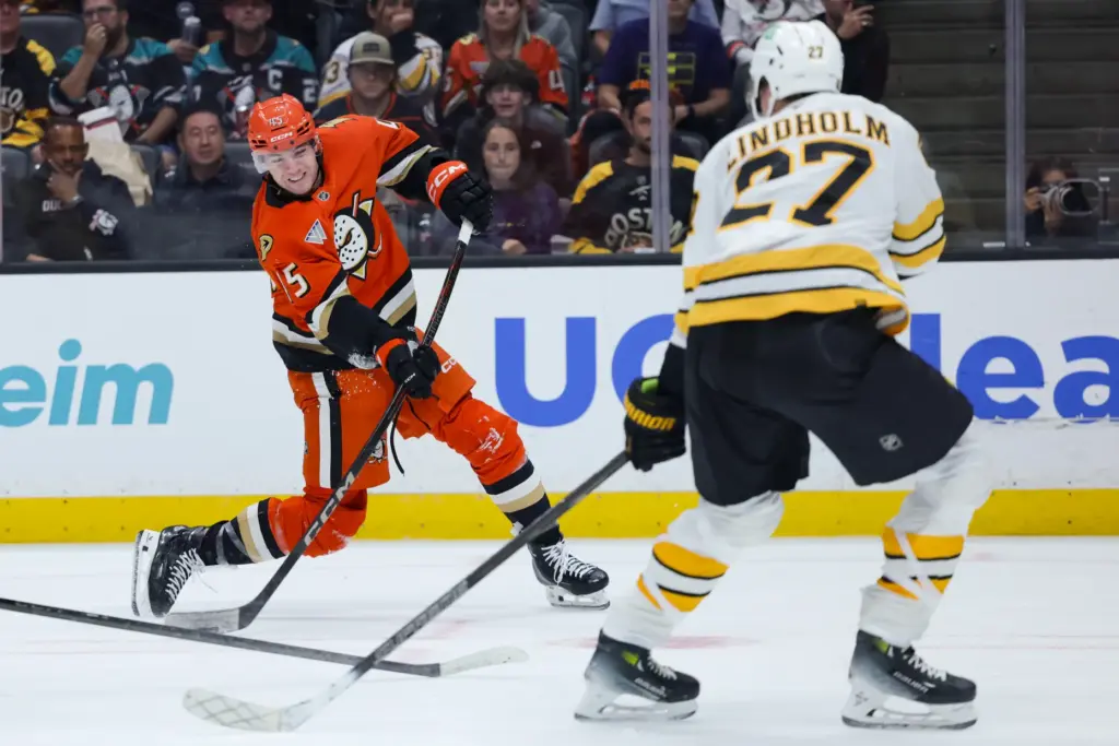 Ducks right wing Beckett Sennecke, left, shoots the puck in...