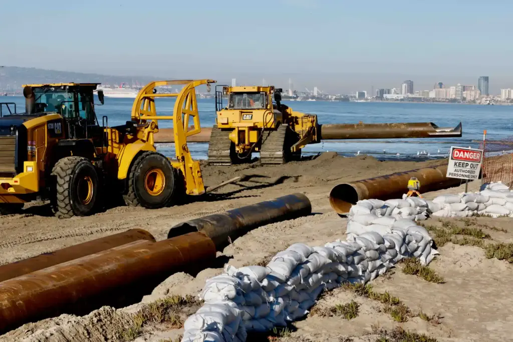 A dredging project to rebuild the beach continues along the...