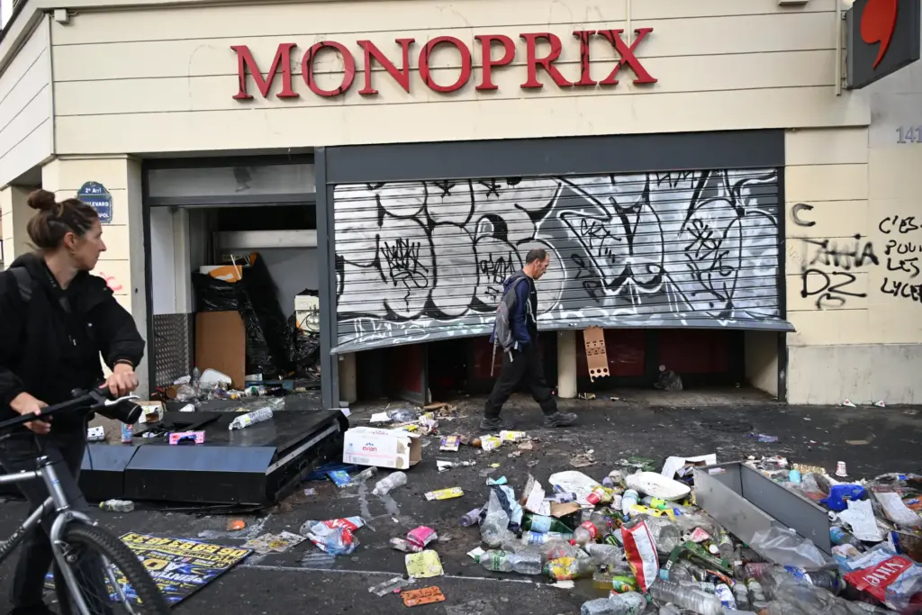 A man walks past a looted store the day after...