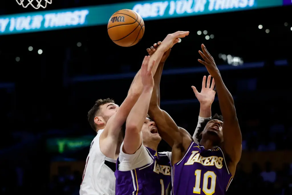 Portland Trail Blazers center Donovan Clingan, left, Lakers center Walker...